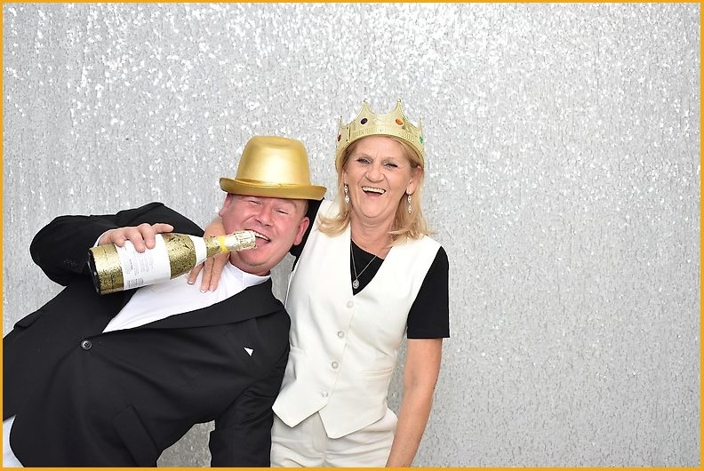 Guests in gold party hats celebrating in the photo booth