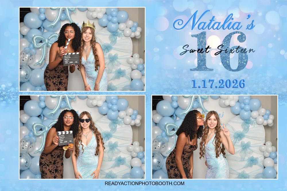Friends holding a clapperboard prop in the photo booth